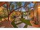 Tranquil backyard featuring a stone pathway, covered pergola, and meticulously manicured garden at 9135 Hickam Ave, Las Vegas, NV 89129