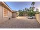 Spacious backyard featuring gravel landscaping, patio area, and privacy fence, perfect for outdoor gatherings at 9135 Hickam Ave, Las Vegas, NV 89129