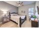 Comfortable bedroom featuring a ceiling fan, neutral color palette, and a window with plantation shutters at 9135 Hickam Ave, Las Vegas, NV 89129