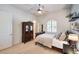 Comfortable bedroom with a decorative cabinet, ceiling fan, and bright natural light at 9135 Hickam Ave, Las Vegas, NV 89129