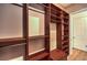 Walk-in closet featuring wooden shelving and clothing racks with carpet flooring at 9135 Hickam Ave, Las Vegas, NV 89129