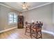 Cozy dining area featuring a wine cooler, a round table with leather chairs, and a ceiling fan at 9135 Hickam Ave, Las Vegas, NV 89129
