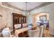 Elegant dining room featuring hardwood floors, stylish lighting, and a large wooden hutch at 9135 Hickam Ave, Las Vegas, NV 89129