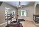 Bright exercise room features an elliptical, treadmill, fireplace, and large mirror at 9135 Hickam Ave, Las Vegas, NV 89129