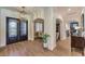 Elegant foyer with hardwood floors, decorative lighting, and arched doorways at 9135 Hickam Ave, Las Vegas, NV 89129