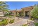 Beautifully landscaped walkway leading to an elegant front door with stonework at 9135 Hickam Ave, Las Vegas, NV 89129