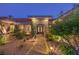 Beautifully landscaped walkway leading to an elegant front door with stonework at 9135 Hickam Ave, Las Vegas, NV 89129