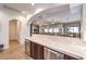 Spacious living area featuring a bar with marble counters and dark wood cabinets and open floor plan at 9135 Hickam Ave, Las Vegas, NV 89129