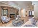 Inviting living room featuring a stone fireplace, neutral furniture, and modern decor at 9135 Hickam Ave, Las Vegas, NV 89129