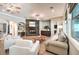 Bright and open living room featuring a stone fireplace, hardwood flooring, and cozy furniture at 9135 Hickam Ave, Las Vegas, NV 89129