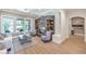 Cozy living room with a stone fireplace, comfortable seating, and plenty of natural light at 9135 Hickam Ave, Las Vegas, NV 89129