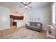 Comfortable living room featuring an open layout, kitchen access, and a decorative rug at 9135 Hickam Ave, Las Vegas, NV 89129