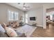 Comfortable living room featuring a ceiling fan, outdoor access, and an adjacent dining area at 9135 Hickam Ave, Las Vegas, NV 89129