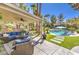 Inviting outdoor living area with comfortable seating, a covered patio, and a refreshing pool at 9135 Hickam Ave, Las Vegas, NV 89129