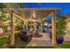 Charming backyard pergola with comfortable seating and views of the manicured landscaping at 9135 Hickam Ave, Las Vegas, NV 89129