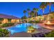 Gorgeous backyard with a sparkling pool, inviting fire pit, and well-manicured landscaping at 9135 Hickam Ave, Las Vegas, NV 89129
