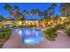 Stunning backyard with a large pool, lush landscaping, and a cozy fire pit area at 9135 Hickam Ave, Las Vegas, NV 89129
