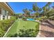 Beautiful backyard featuring putting green and lush landscaping at 9135 Hickam Ave, Las Vegas, NV 89129