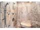 Detailed view of a luxurious shower with a bench, and beautiful tile work at 9135 Hickam Ave, Las Vegas, NV 89129