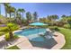 Stunning backyard pool area with lounge chairs, mature palms, and lush landscaping at 9135 Hickam Ave, Las Vegas, NV 89129