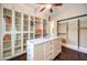 Expansive walk-in closet with glass cabinets, an island, and ample storage at 9135 Hickam Ave, Las Vegas, NV 89129