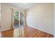 Cozy bedroom featuring hardwood floors and a sliding door that opens to a private balcony at 9325 W Desert Inn Rd # 104, Las Vegas, NV 89117