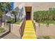 Inviting stairway leading to the front door, complemented by colorful landscaping and a well-maintained exterior at 9325 W Desert Inn Rd # 104, Las Vegas, NV 89117