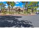 Attractive building with a stone facade, well-maintained landscaping, and ample parking spaces at 9325 W Desert Inn Rd # 104, Las Vegas, NV 89117