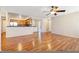 Open concept living area with beautiful hardwood floors, seamlessly flowing into a kitchen with stainless steel appliances at 9325 W Desert Inn Rd # 104, Las Vegas, NV 89117