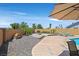 Tranquil backyard featuring a pool, fire pit area, well-maintained landscaping, and inviting lounging spots for outdoor enjoyment at 100 Crossfoot Terrace Ct, Henderson, NV 89002