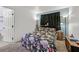 Comfortable bedroom with floral bedding, carpeting, and a door leading to the bathroom at 100 Crossfoot Terrace Ct, Henderson, NV 89002