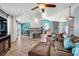 The open concept living area features herringbone floors, a stone fireplace, and lots of space for living and entertaining at 100 Crossfoot Terrace Ct, Henderson, NV 89002