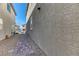 A side yard with brick pathway and gravel, adjacent to the house at 10042 Bismuth St, Las Vegas, NV 89183