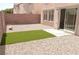 Low-maintenance backyard with gravel, artificial turf, and a patio sliding door at 1025 Appaloosa Hills Ave, North Las Vegas, NV 89081