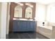 Stylish bathroom featuring a modern vanity, dual mirrors, and a sleek bathtub at 1025 Appaloosa Hills Ave, North Las Vegas, NV 89081