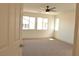 Bright bedroom with large windows, ceiling fan, and neutral carpet offers modern comfort at 1025 Appaloosa Hills Ave, North Las Vegas, NV 89081