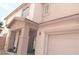 Two-story home featuring a covered porch, attached garage, and stucco exterior at 1025 Appaloosa Hills Ave, North Las Vegas, NV 89081