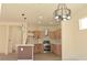 Open kitchen with stainless steel appliances, light wood cabinets, and island at 1025 Appaloosa Hills Ave, North Las Vegas, NV 89081