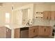 Open kitchen features a marble island, stainless steel appliances, and wooden cabinets at 1025 Appaloosa Hills Ave, North Las Vegas, NV 89081