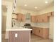 Spacious kitchen with stainless steel appliances, wood cabinets and island at 1025 Appaloosa Hills Ave, North Las Vegas, NV 89081