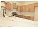 Kitchen with marble countertops, stainless appliances, modern hood, and light wood cabinets at 1025 Appaloosa Hills Ave, North Las Vegas, NV 89081