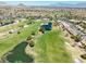 Wide aerial shot of the golf course and adjacent homes, blending leisure with comfortable living at 10413 Marymont Pl, Las Vegas, NV 89134