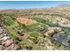Scenic aerial view of the golf course and surrounding neighborhood, offering a serene desert landscape at 10413 Marymont Pl, Las Vegas, NV 89134