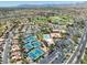 Aerial view showcasing golf course, recreation center with pool and tennis courts in a well-maintained community at 10413 Marymont Pl, Las Vegas, NV 89134