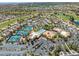 Aerial view of community with golf course, pool, recreation center, tennis courts, and parking at 10413 Marymont Pl, Las Vegas, NV 89134