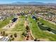 High-angle view of the golf course with lush fairways, water features, and well-spaced homes at 10413 Marymont Pl, Las Vegas, NV 89134