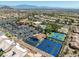 Community aerial view featuring tennis courts, pool, clubhouse, parking, and beautiful desert landscaping with mountain views at 10413 Marymont Pl, Las Vegas, NV 89134