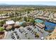 Community center with pool, tennis, parking, and desert landscaping in aerial view, with homes stretching towards the horizon at 10413 Marymont Pl, Las Vegas, NV 89134