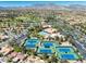 Scenic aerial view highlights the lush community with golf course, pool, and tennis courts against a mountain backdrop at 10413 Marymont Pl, Las Vegas, NV 89134