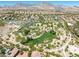Scenic aerial view of the residential community featuring a park, green spaces, and mountain backdrop at 10413 Marymont Pl, Las Vegas, NV 89134